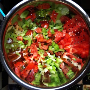 Mixing the tomatoes.